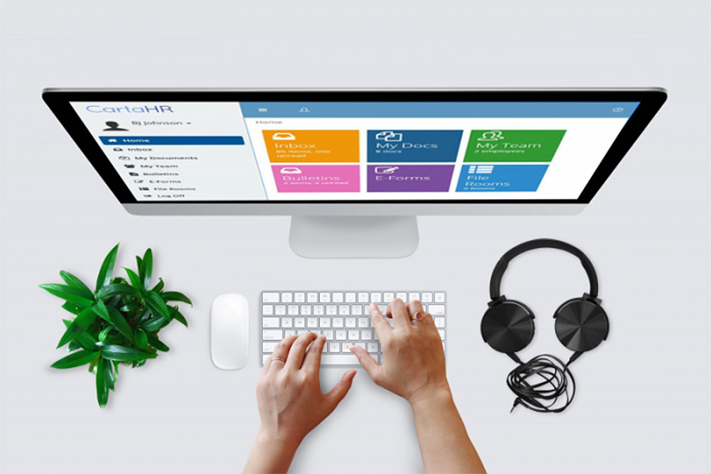 Hands on a keyboard in front of a desktop monitor with process automation software on the screen.