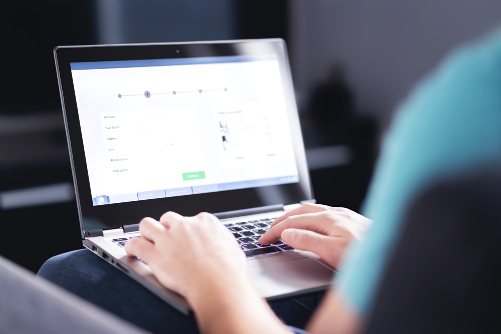 A persons arms shown working on a laptop. Digital transformation services allow their records to be securely accessed from anywhere.